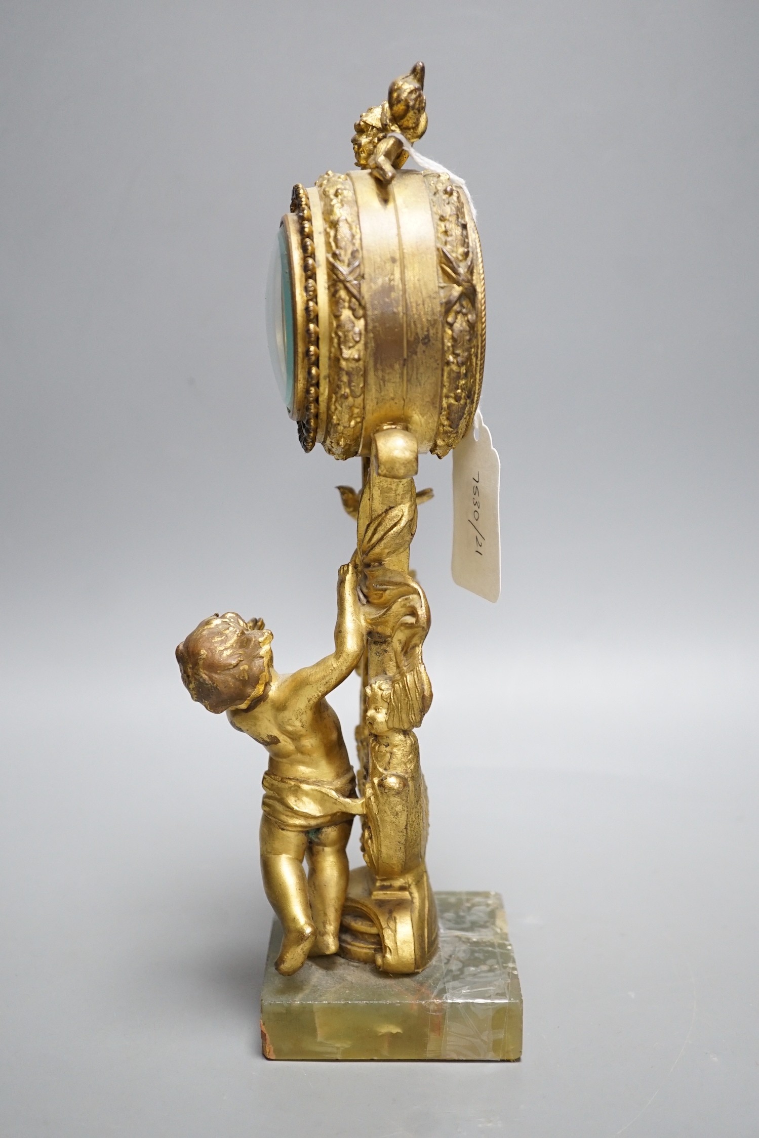 An early 20th century gilt metal cherubic mantel timepiece on onyx base, 29cm